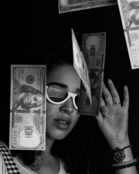picture of a woman with money falling around her