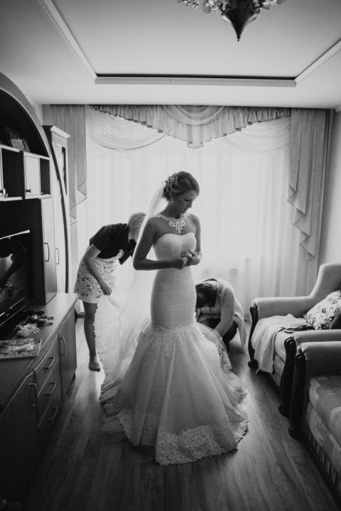Bride getting into her luxury wedding dress before her luxury wedding event in San Diego with Ivory and Lace Creative Weddings